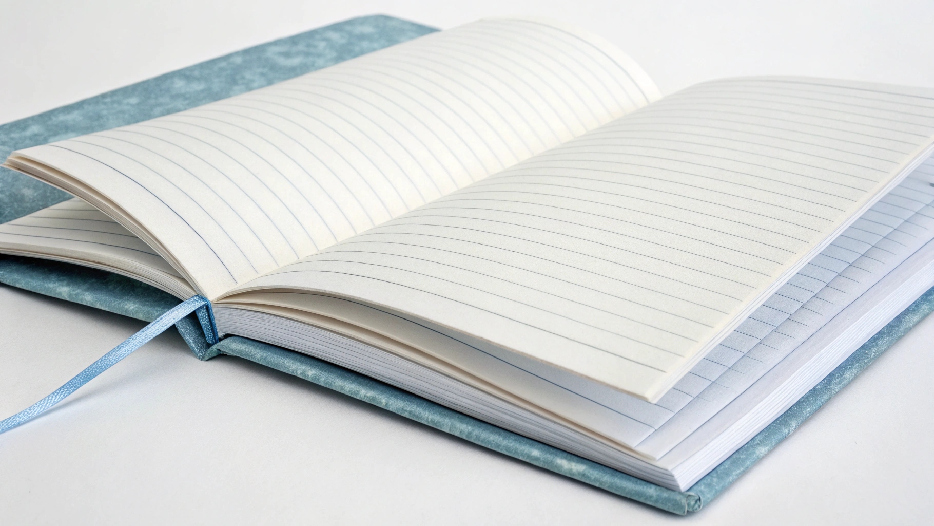 An open A5 notebook showing the thickness of its pages